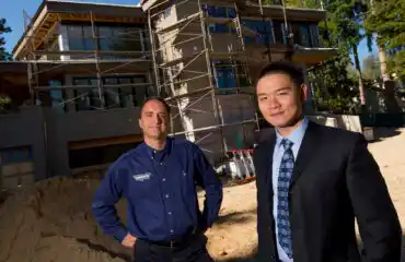 Todd Lozier, left, and Bangze Wang of Lochwood-Lozier Custom Homes, at the site of an 8,000-square-foot home they are building in Medina, WA, east of Seattle, for a Chinese investor.